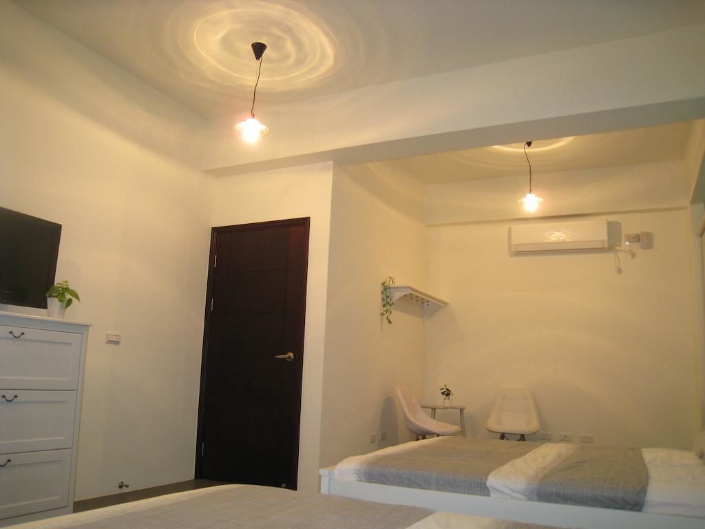 A bedroom with a bed, a dresser, a chair, and a desk.