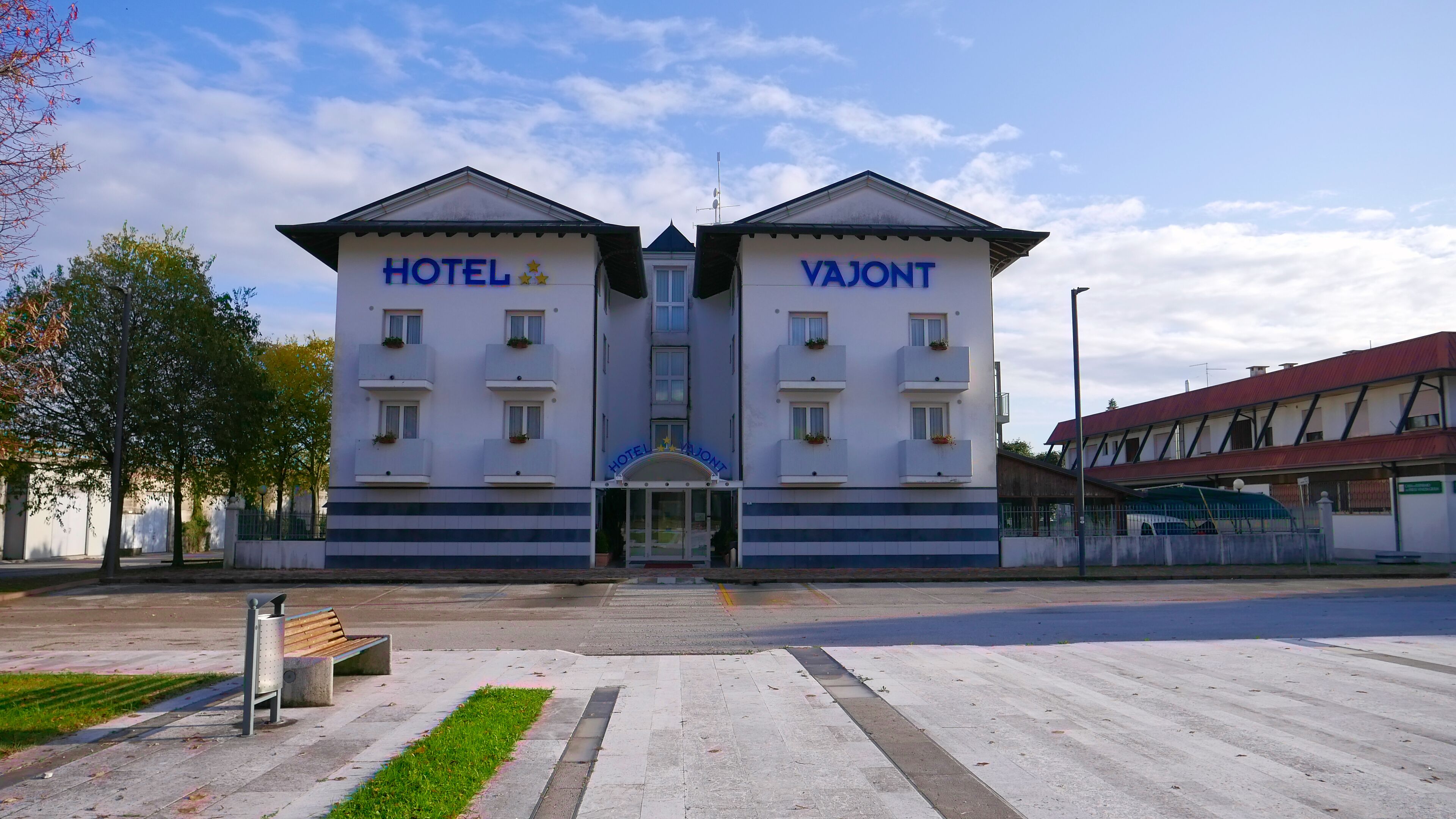 A two-story hotel with a central entrance and balconies on each floor.