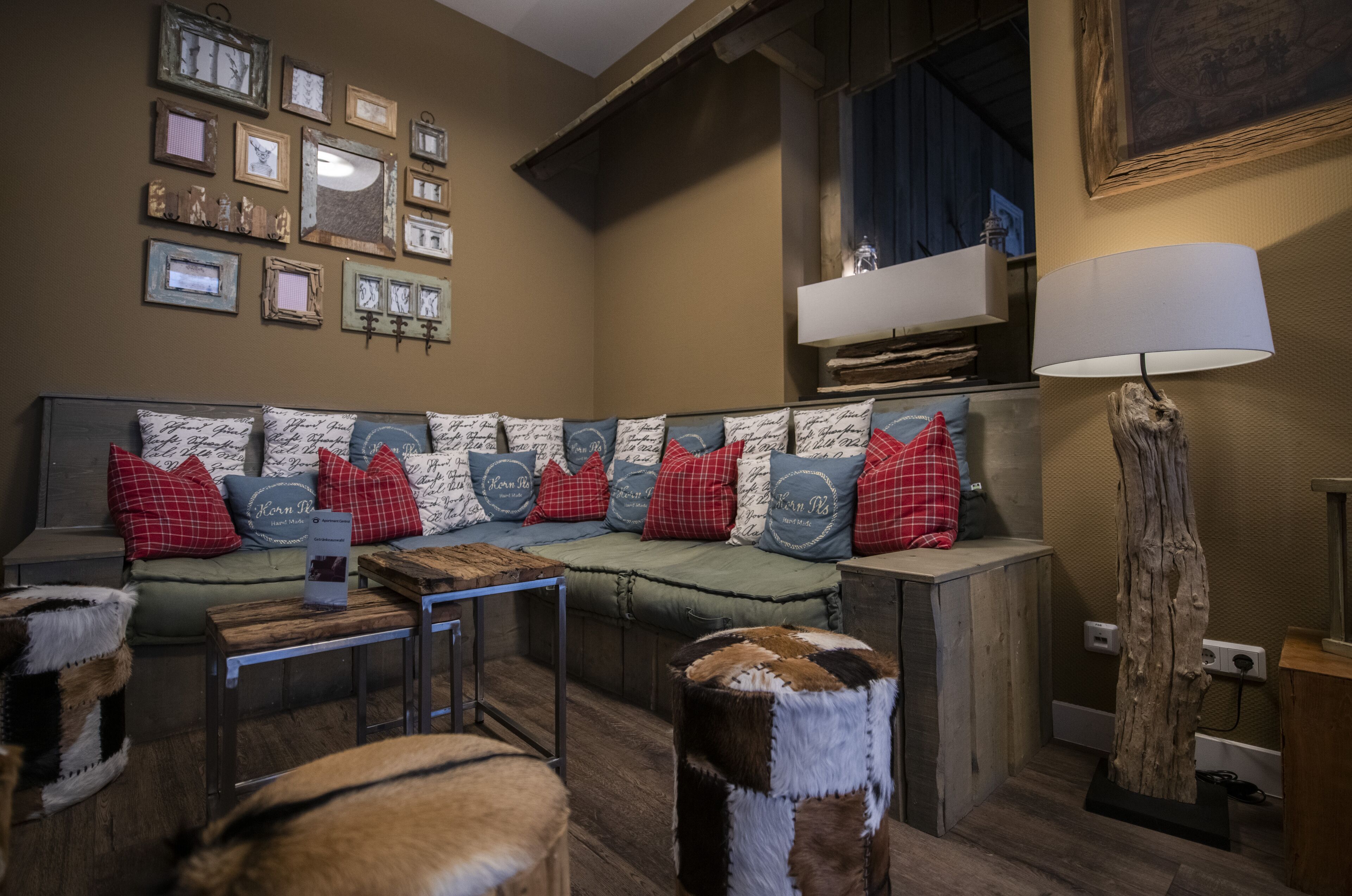 A cozy living room with a sectional sofa, a coffee table, and a lamp.