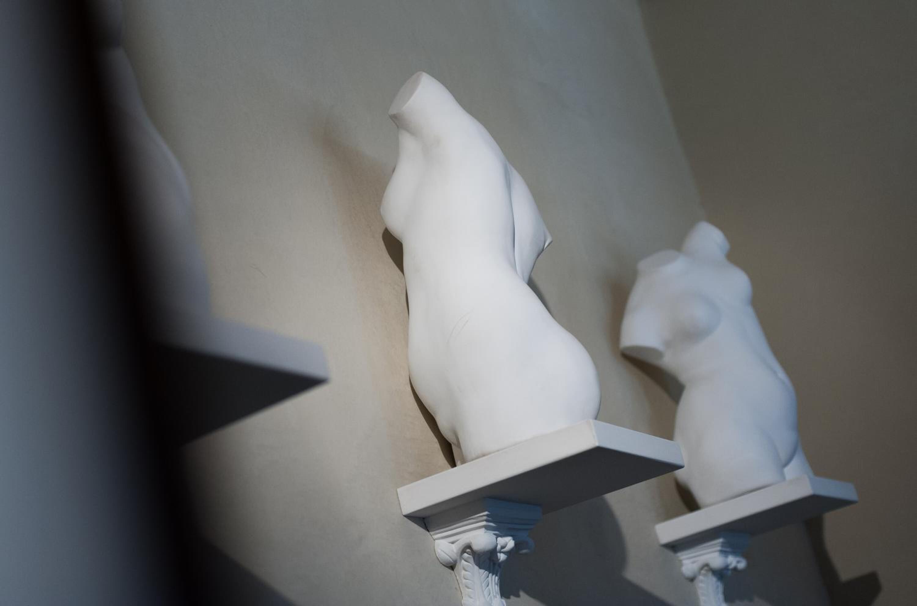 A sculpture of a woman and a child on a pedestal.