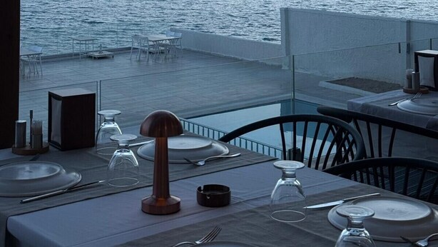 A table set for dining with a view of the sea and distant mountains. - Lades Hotel (Silifke)