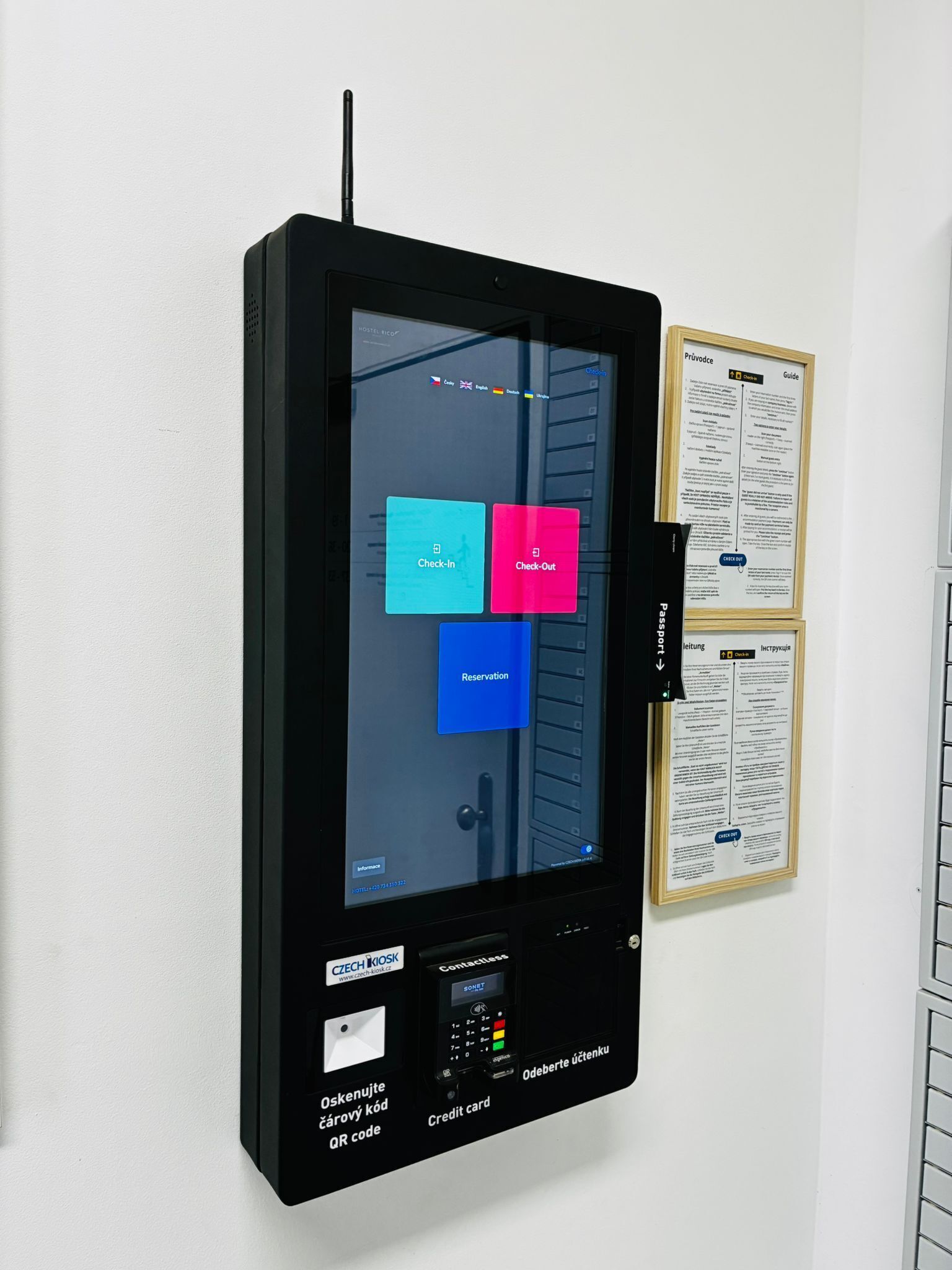 A self-service kiosk with options for check-in, check-out, and reservation.