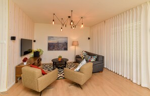 Deluxe Apartment, 2 Bedrooms | Living area | 55-inch Smart TV with cable channels, TV - Sokolov 35 Boutique Apartment (Nahariya)