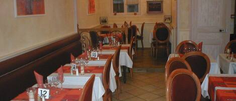 A restaurant with tables set for dining, numbered placemats, and chairs.