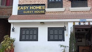 A multi-story building with a sign reading "EASY HOMES GUEST HOUSE". - Easy Homes (Lalitpur)