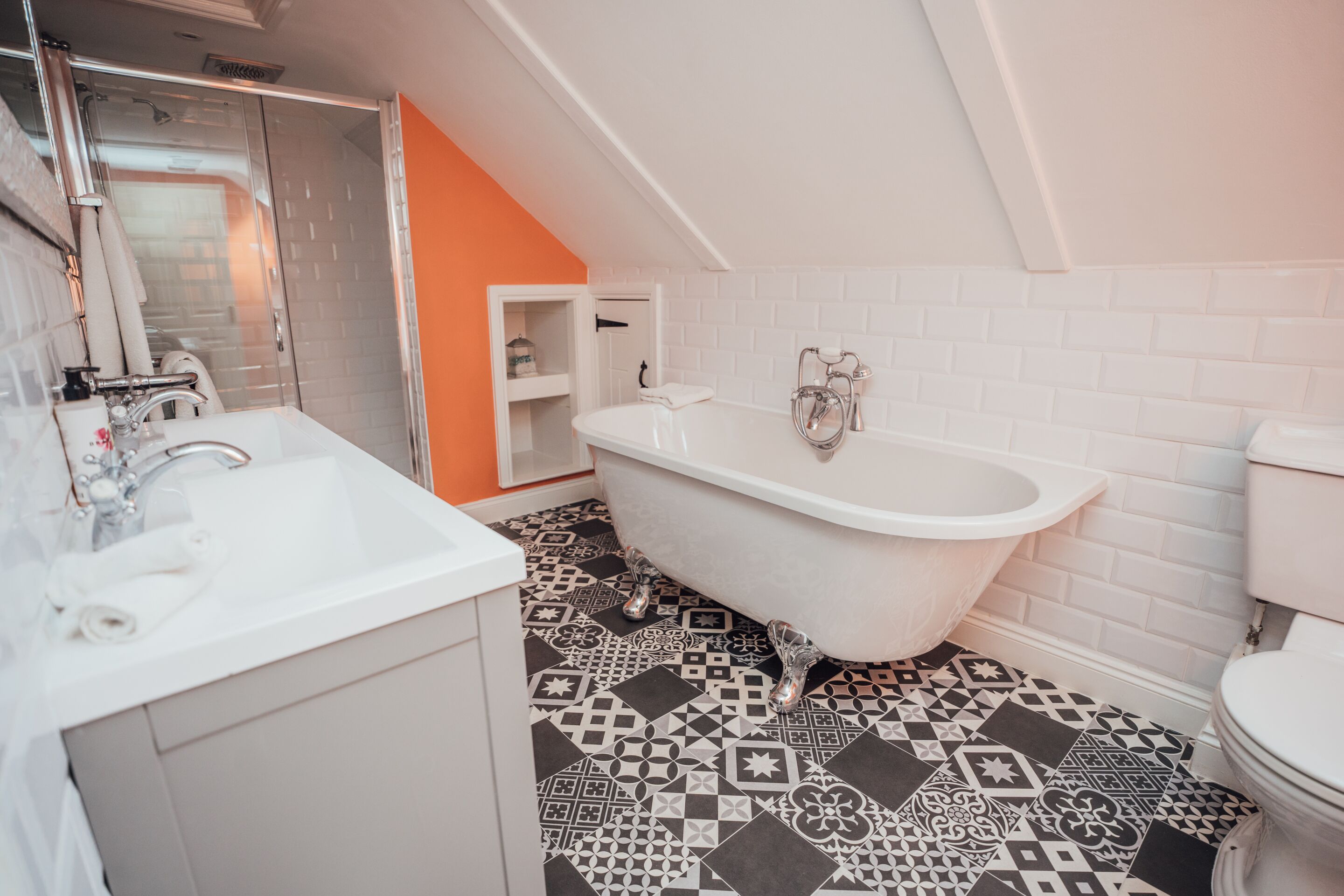 A bathroom with a freestanding bathtub, a sink, and a toilet.