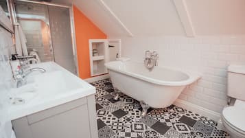 A bathroom with a freestanding bathtub, a sink, and a toilet.