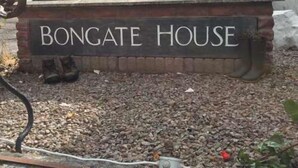 A sign reading "BONGATE HOUSE" with a gravel driveway and a parked car in the background. - Bongate House (Appleby-in-Westmorland)