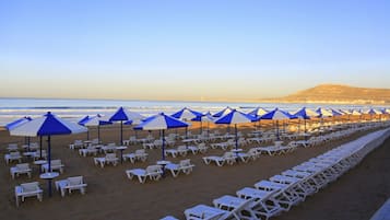 On the beach, sun-loungers, beach umbrellas