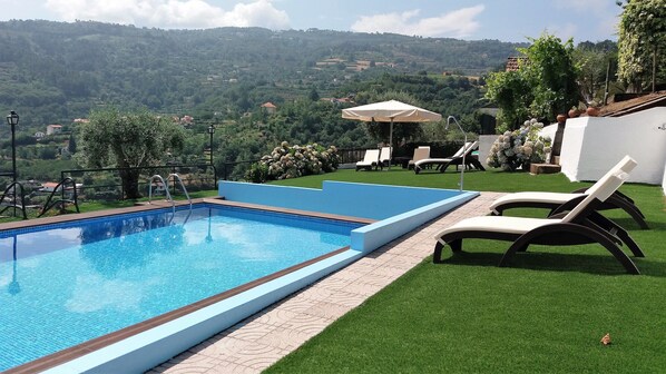 Seasonal outdoor pool, a rooftop pool, pool umbrellas, pool loungers