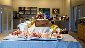 A buffet table with various meats and condiments. - Karlskoga Hotell (Karlskoga)