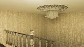 A staircase with a metal railing and a decorative chandelier. - Vertu Hotel (Istanbul)