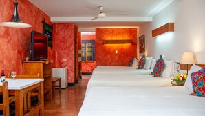 A hotel room with two beds, a TV, a desk, and a dining area. - Hotel Panchoy (Antigua Guatemala)