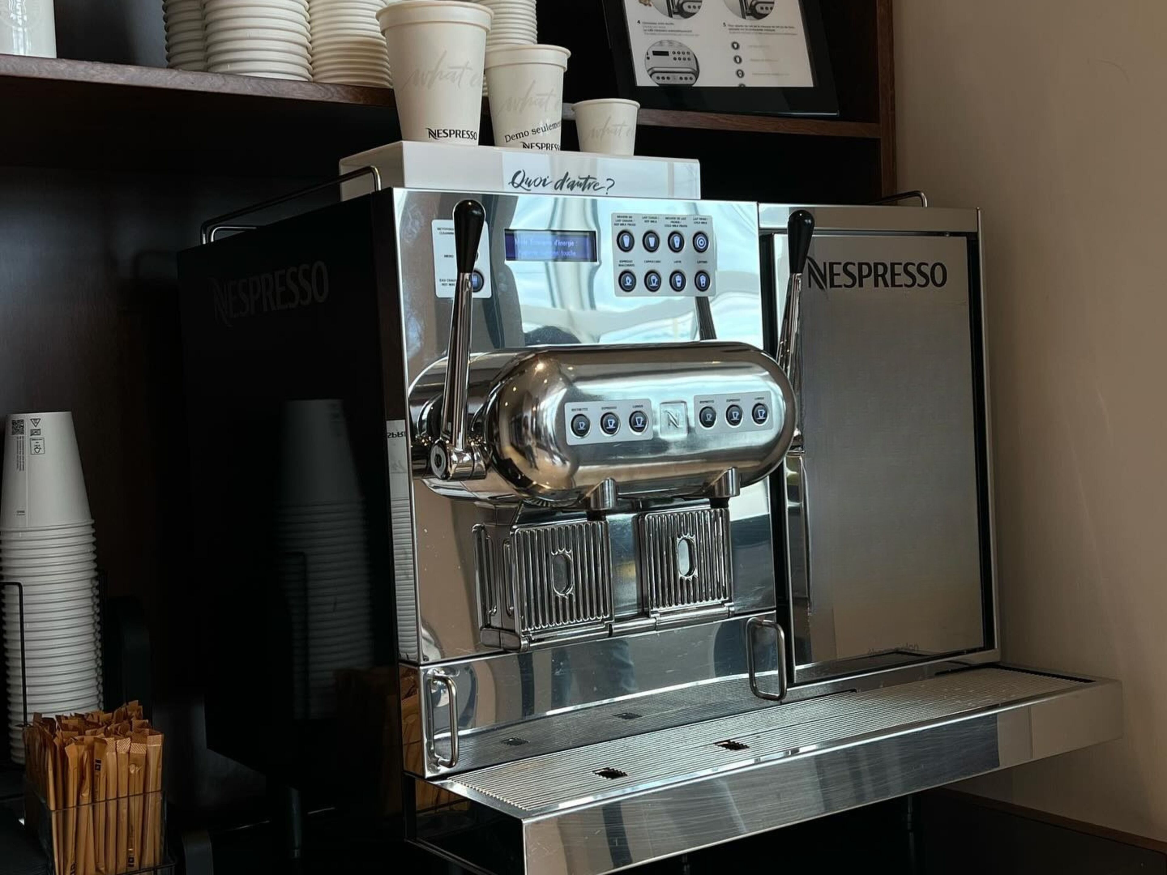 A Nespresso coffee machine with a digital display and multiple buttons.