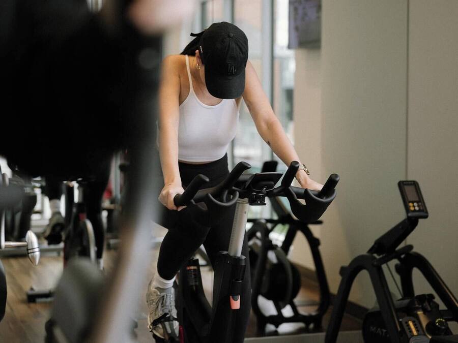 A gym with various exercise equipment, including stationary bikes and treadmills.
