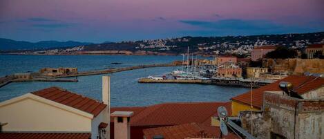 A coastal town with buildings, a marina, and a view of the sea.
