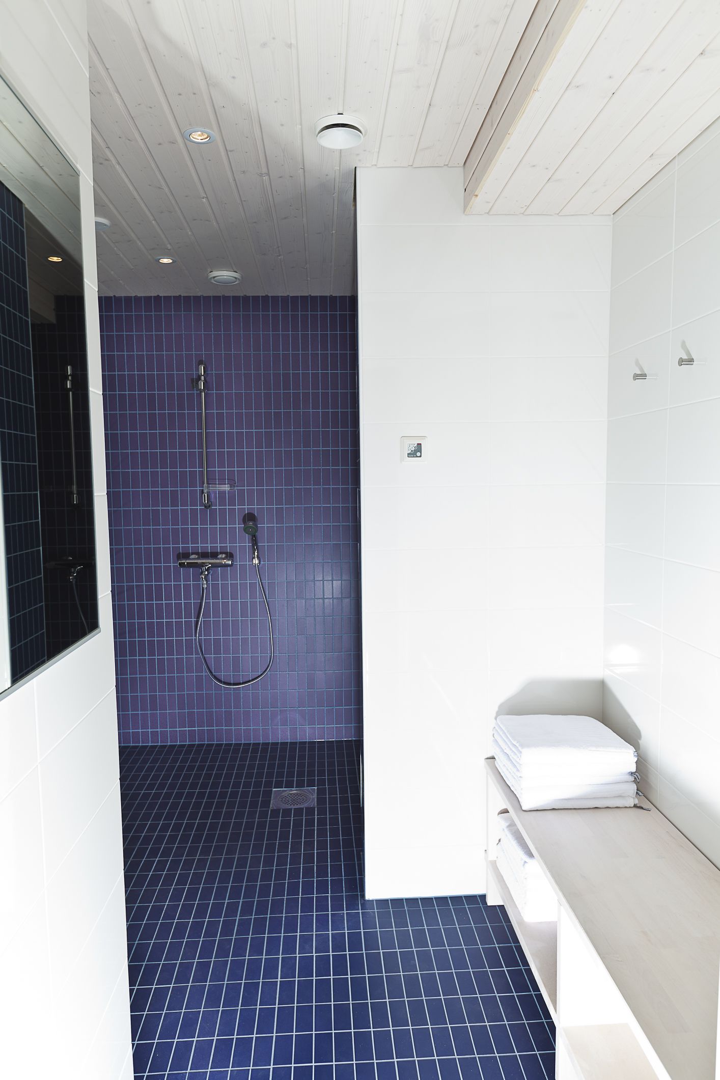 A bathroom with a shower, a toilet, and a sink.