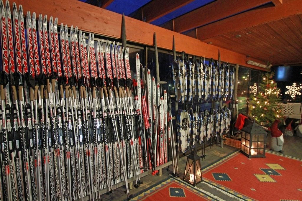 A ski shop with rows of skis and snowboards.