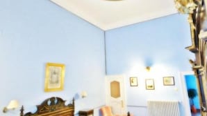 A bedroom with a bed, a nightstand, a dresser, and a ceiling mural. - B&B Casa Cavalli (Lucera)