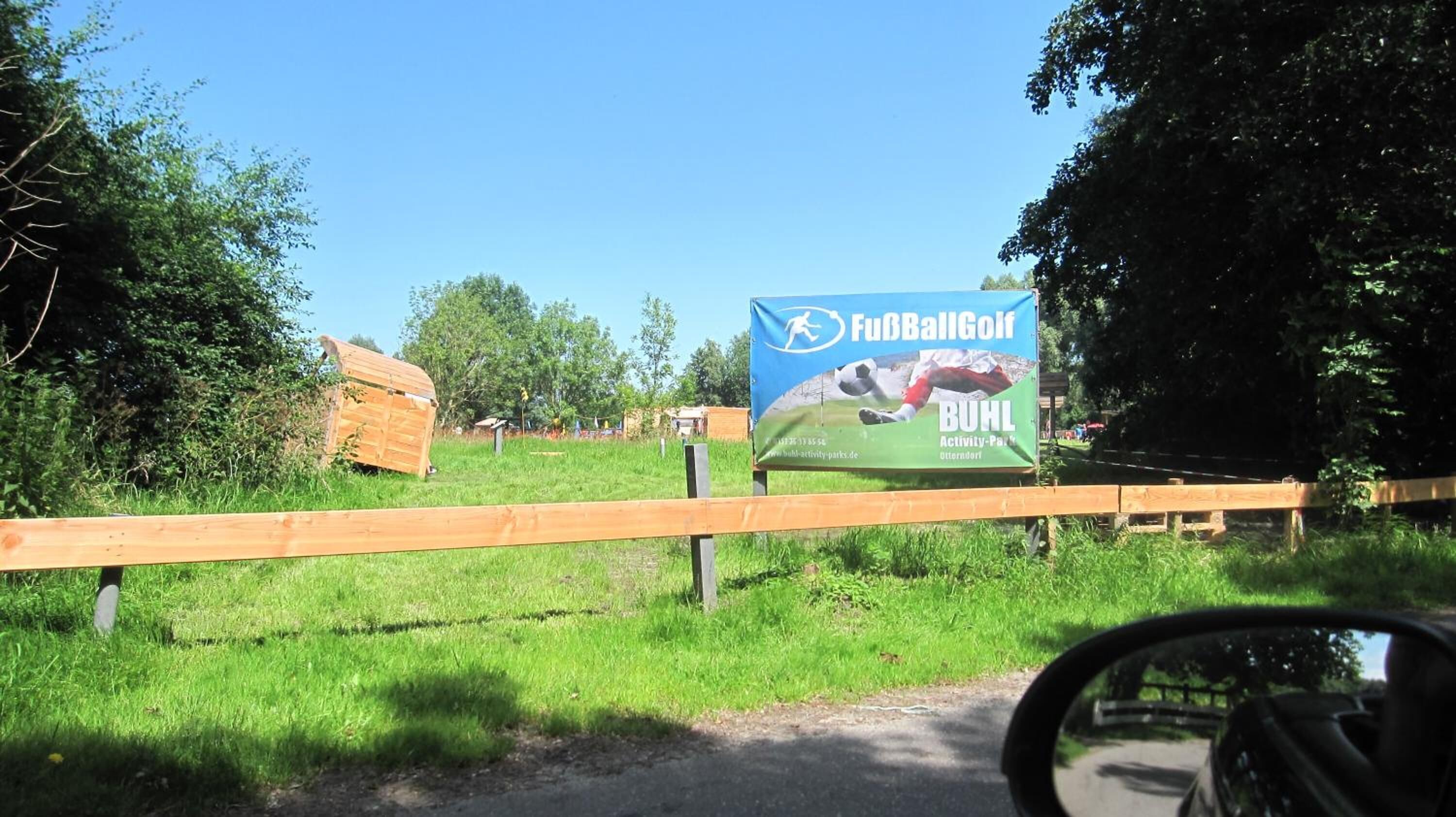 A signboard for a sports facility with a running track and a football field.