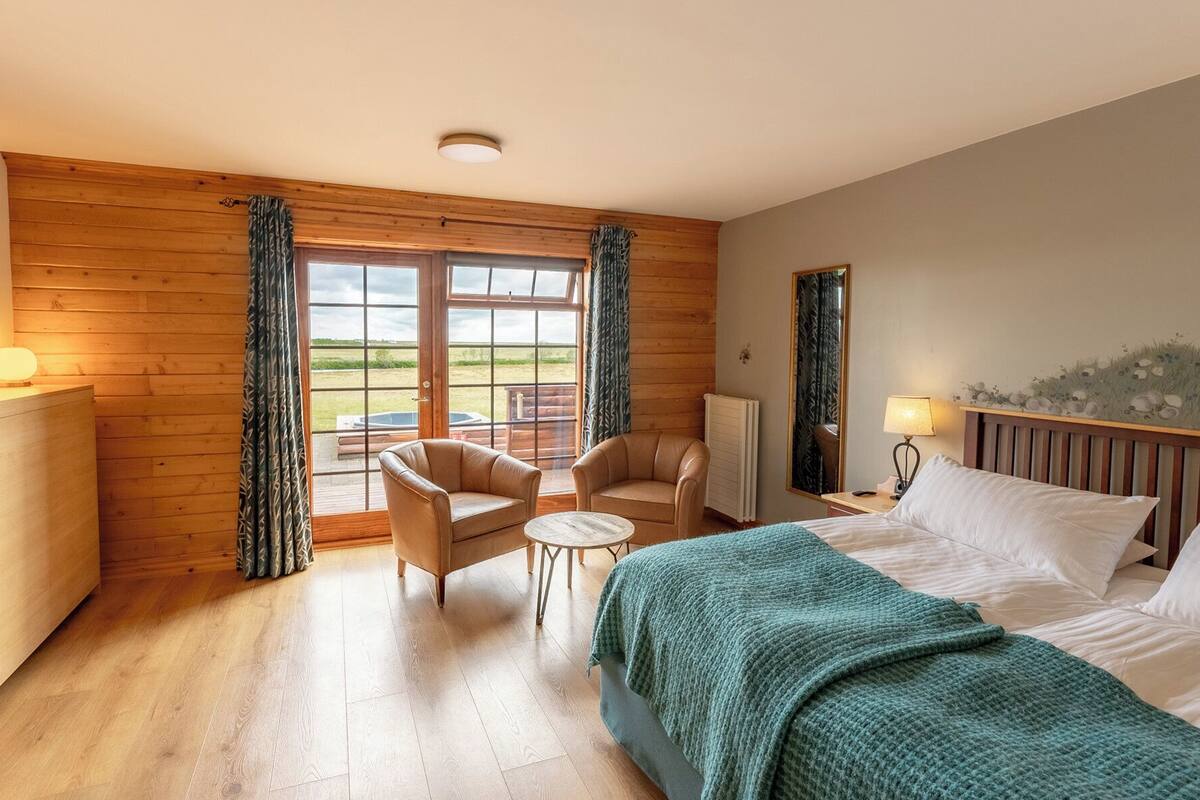 deluxe triple room with river view and hot tub access | hypo-allergenic bedding, minibar, in-room safe, desk