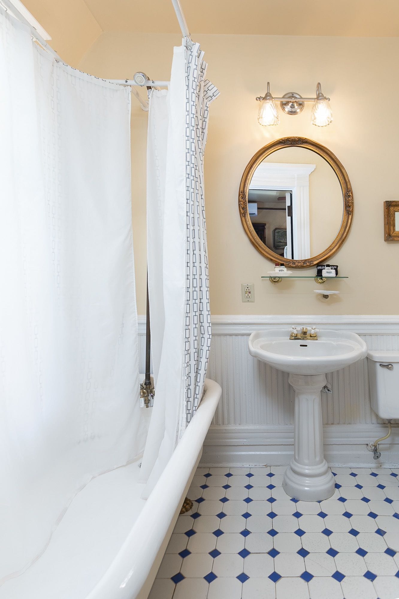 A bathroom with a bathtub, a sink, and a mirror.