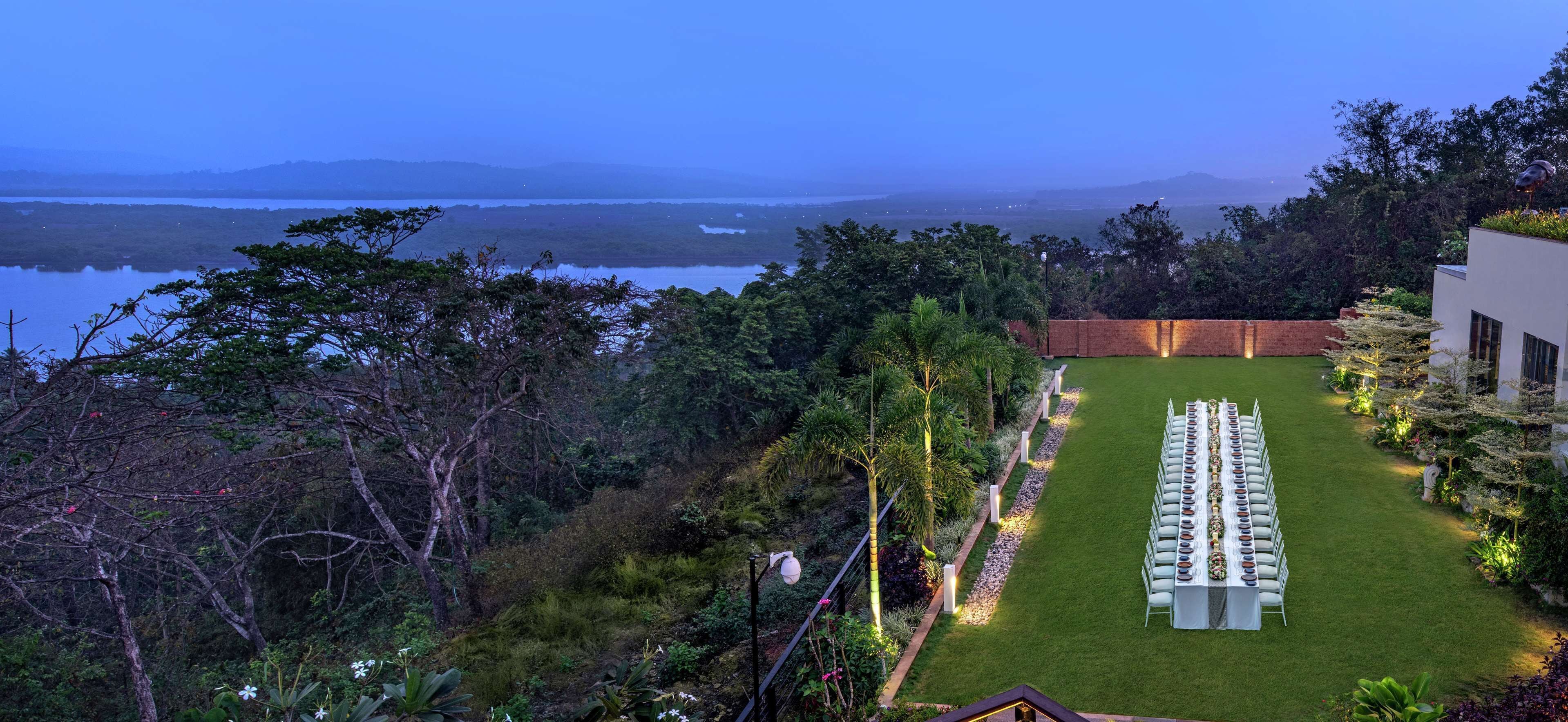 A well-maintained outdoor seating area with a view of a body of water and distant hills.