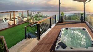 A rooftop terrace with a hot tub, outdoor seating, and a view of the landscape. - DoubleTree by Hilton Goa-Panaji (Panaji)