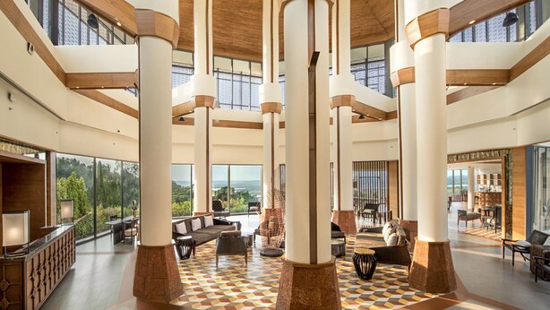A spacious lobby with high ceilings, large columns, and a checkered floor pattern. - DoubleTree by Hilton Goa-Panaji (Panaji)