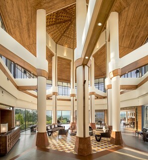 A spacious lobby with high ceilings, large columns, and a checkered floor pattern. - DoubleTree by Hilton Goa-Panaji (Panaji)