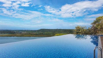 Outdoor pool, open 8:00 AM to 8:00 PM, pool umbrellas, pool loungers