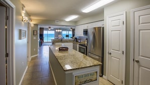 A kitchen with granite countertops, stainless steel appliances, and a sign reading "BEACH HOUSE RULES". - Summerlin-Beachfront for Late Summer!  5 Star! (Fort Walton Beach)