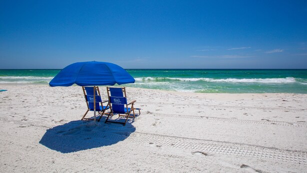 A beach with a blue umbrella and two beach chairs. - Summerlin-Beachfront for Late Summer!  5 Star! (Fort Walton Beach)