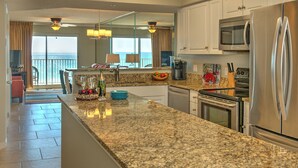 A modern kitchen with granite countertops, stainless steel appliances, and a view of the ocean. - Summerlin-Beachfront for Late Summer!  5 Star! (Fort Walton Beach)