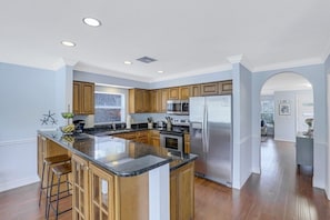 Enjoy cooking in this well-equipped kitchen with a central island, oven, and microwave.