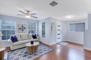Relax in this inviting living room with a sofa, coffee table, and patterned rug.