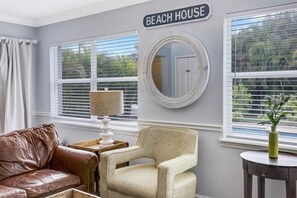 Relax in this cozy space with a brown leather sofa and armchair, perfect for unwinding.