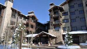 A ski resort with a stone building, wooden balconies, and a covered entrance labeled "Arrow Leaf". - Luxury Ski-In, Ski-Out Arrowleaf Penthouse  With Panoramic Views (Park City)