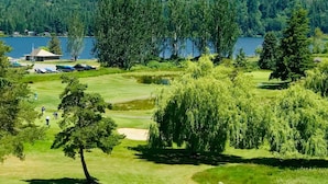 A golf course with a lake and forested hills in the background. - Movie Theater! Hot Tub! Private Rental 3 Bedrooms and 2 Bathrooms. (Bellingham)