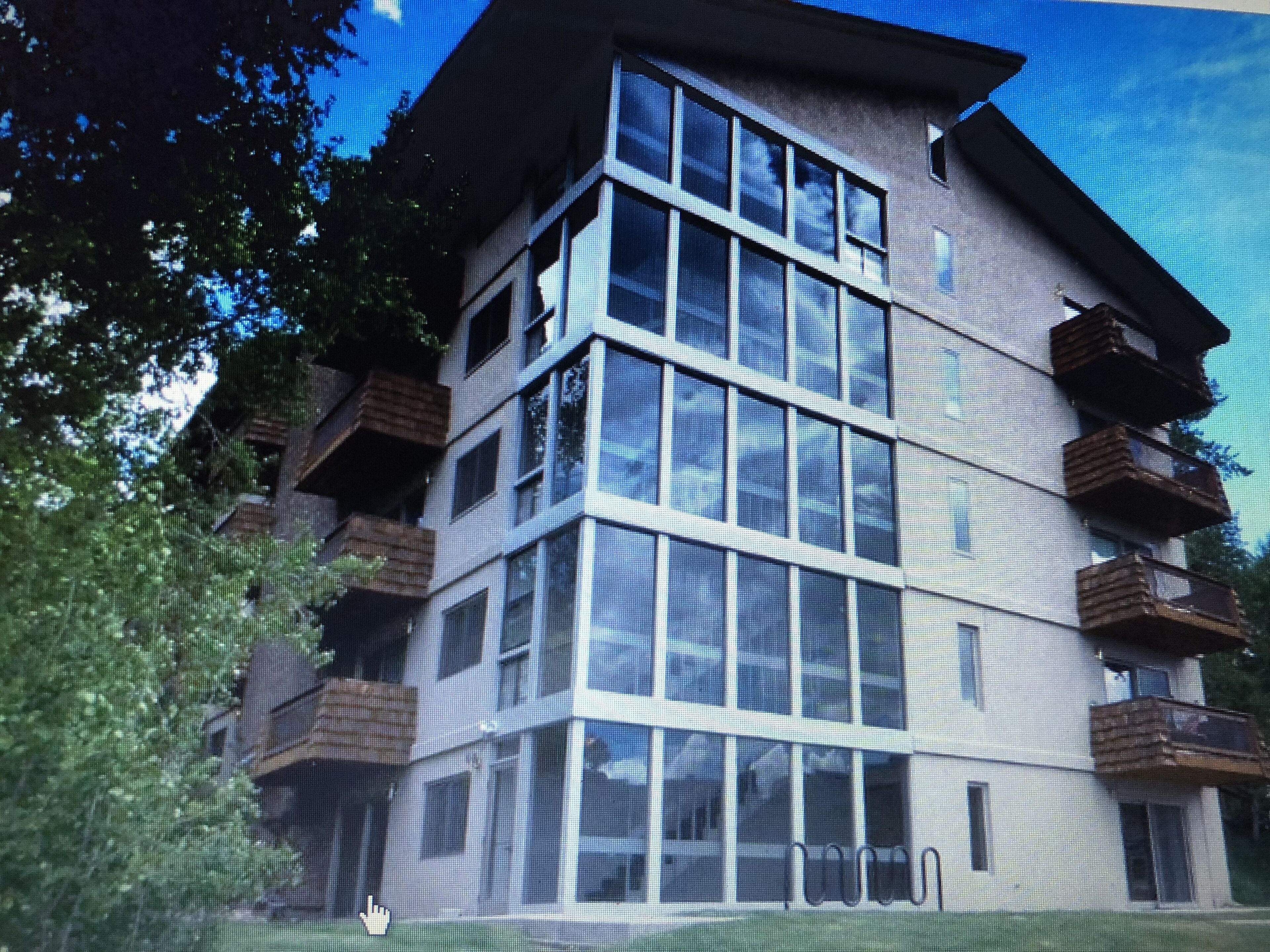 A multi-story building with large windows and balconies.
