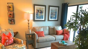 A living room with a sofa, armchair, side table, lamp, and a coffee table. - PARADISE-Anglers Cove Waterfront Designer Condo (Marco Island)