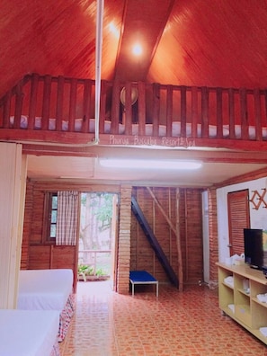A wooden interior with a staircase, a bed, and a shelf with towels. - Phurua Bussaba Resort & Spa (Phu Ruea)