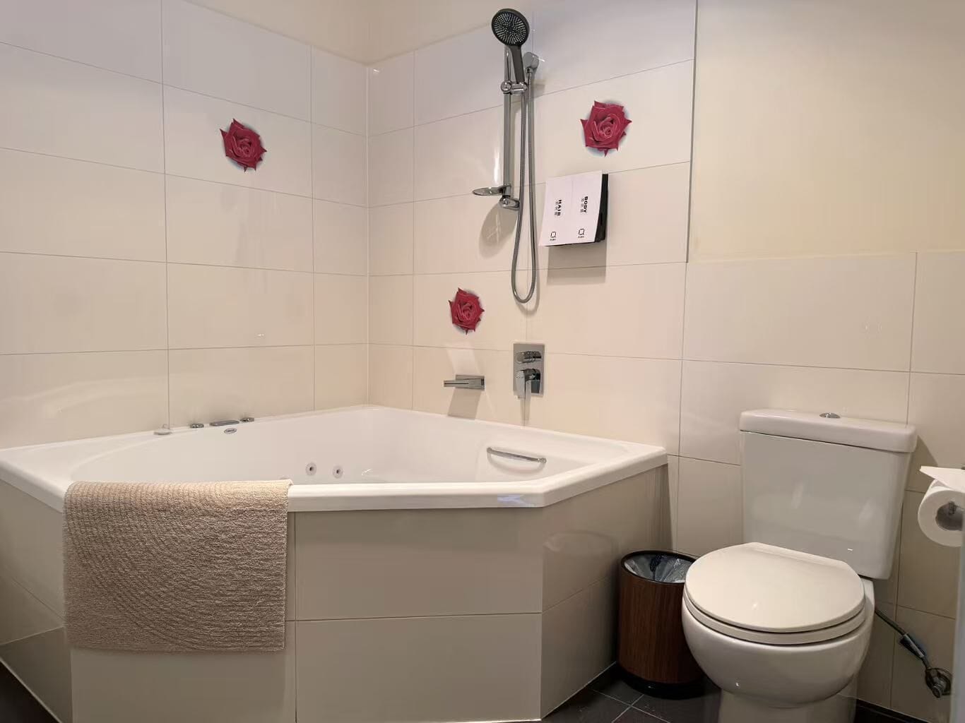 Un baño con bañera, inodoro y un cubo de basura.
