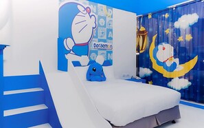A children's bedroom with a bed, a wall mural, and a window with a moon and stars design.