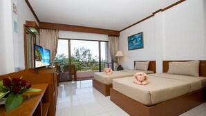 A hotel room with two beds, a desk with a TV, a balcony with a view of trees and a beach, and a painting on the wall. - The Princess Beach Resort (Klaeng)