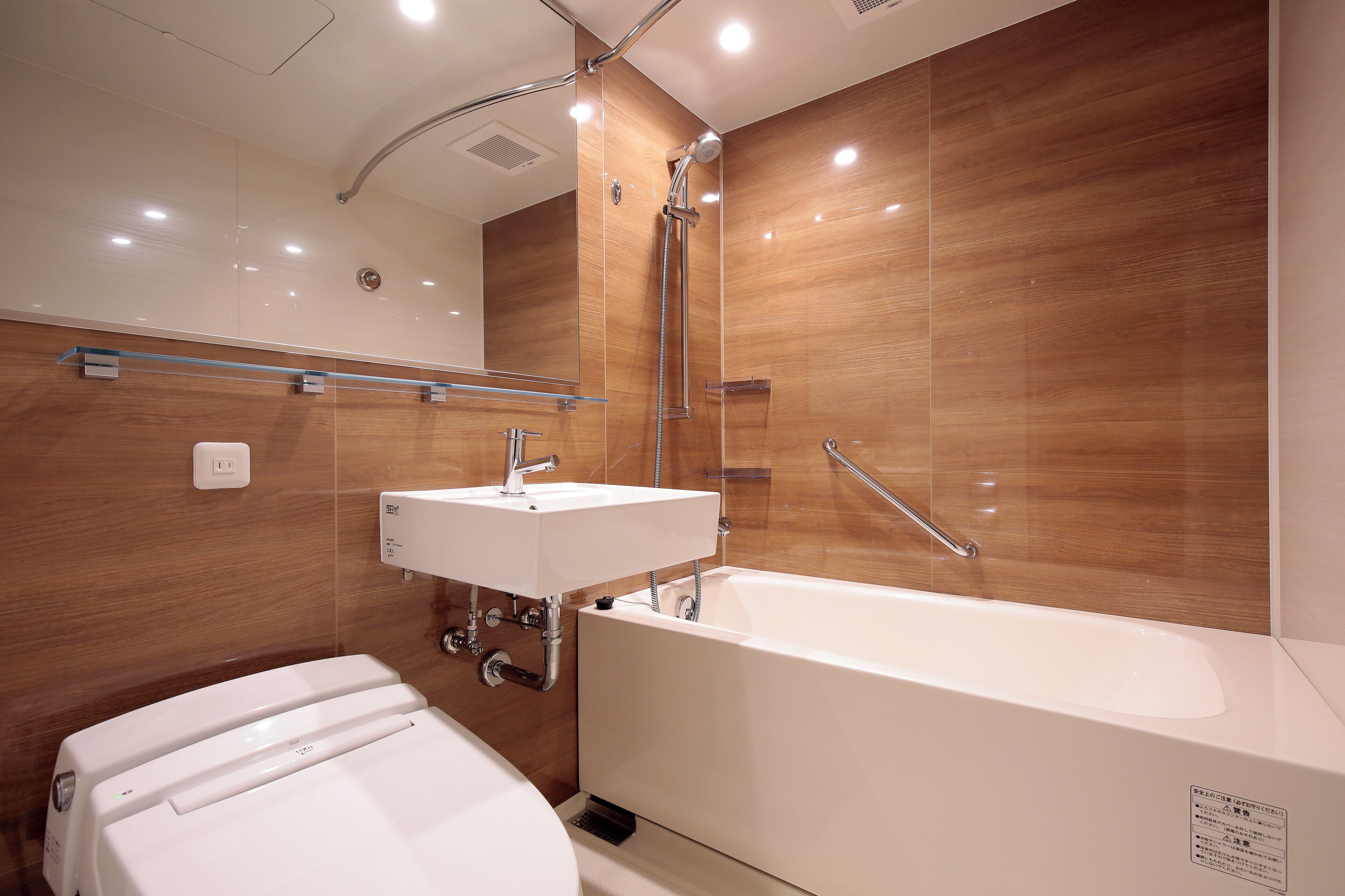 A modern bathroom with a bathtub, a sink, and a toilet.
