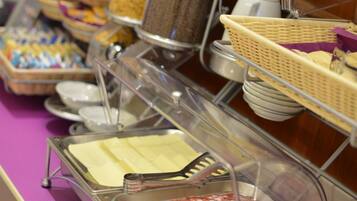 A buffet with various food items including pasta, meats, and eggs.