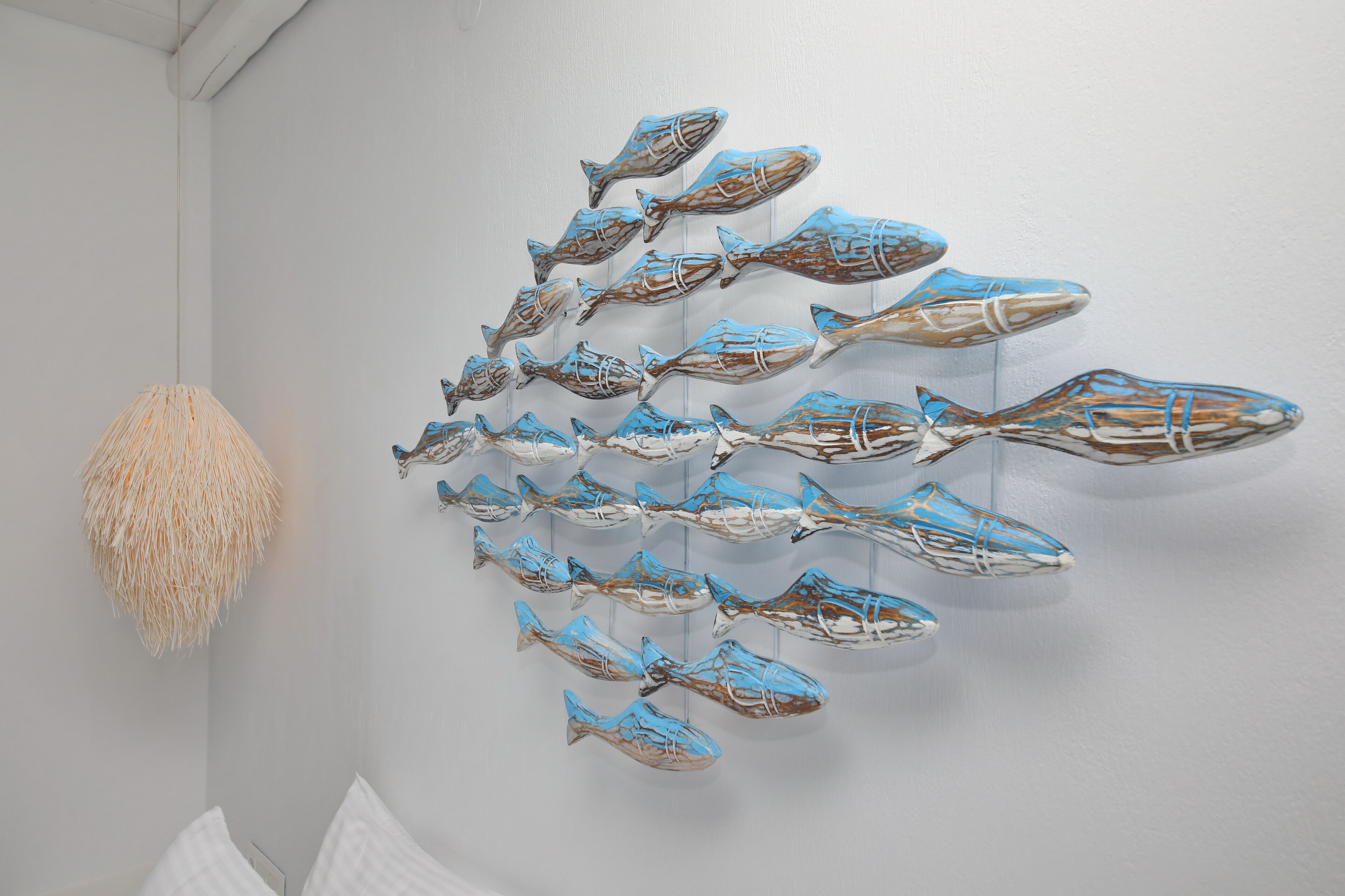 A wall with a series of fish-shaped decorations.