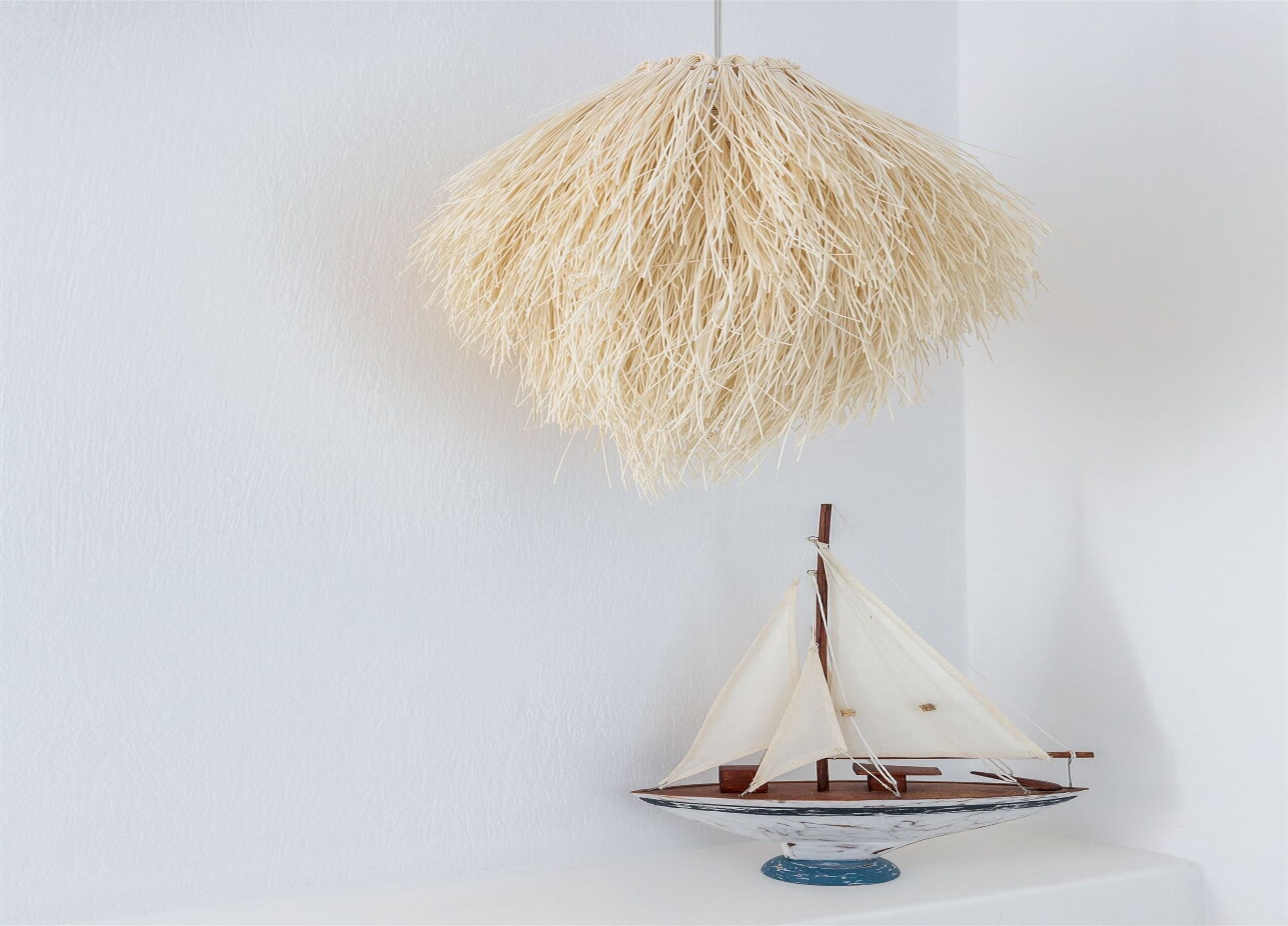 A model sailboat on a white surface.