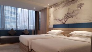 A hotel room with a large window, a sofa, two beds, and a mural on the wall. - Kaiserdom Hotel Airport Branch (Guangzhou)